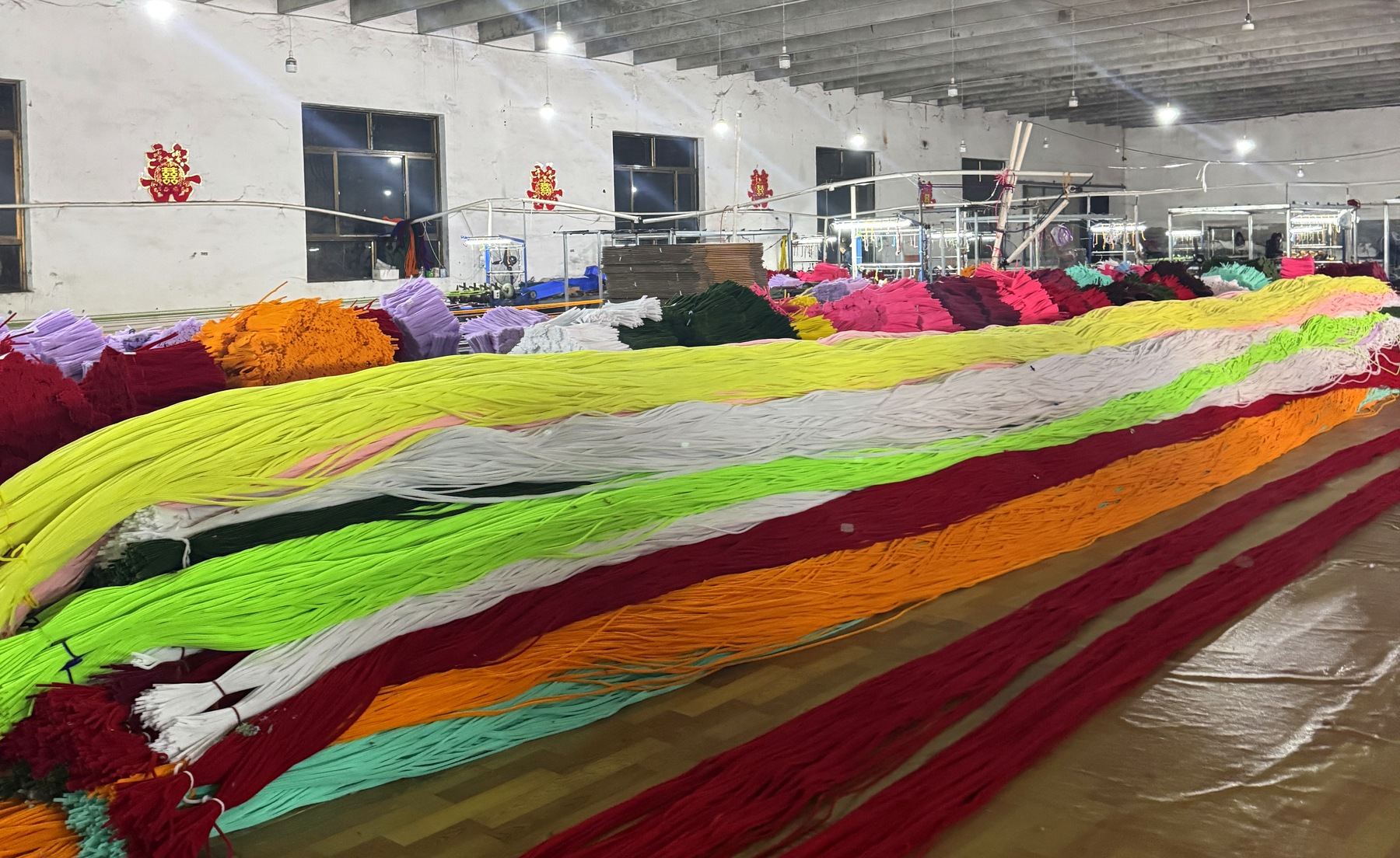 Colorful chenille stems arranged across the factory production floor